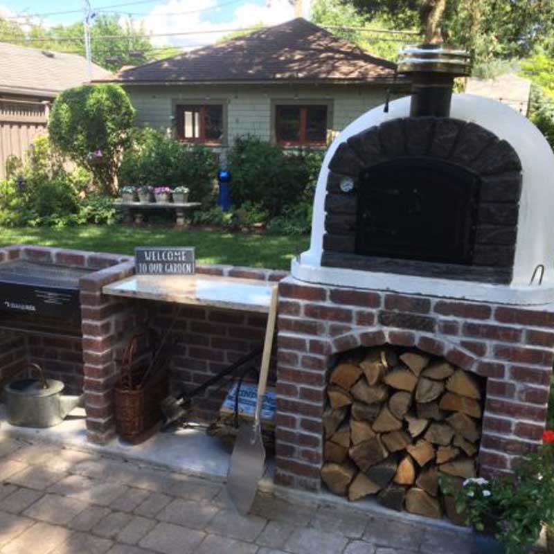Outdoor Stone Kitchen With Firebrick Pizza Oven and Large Rotisserie bbq
